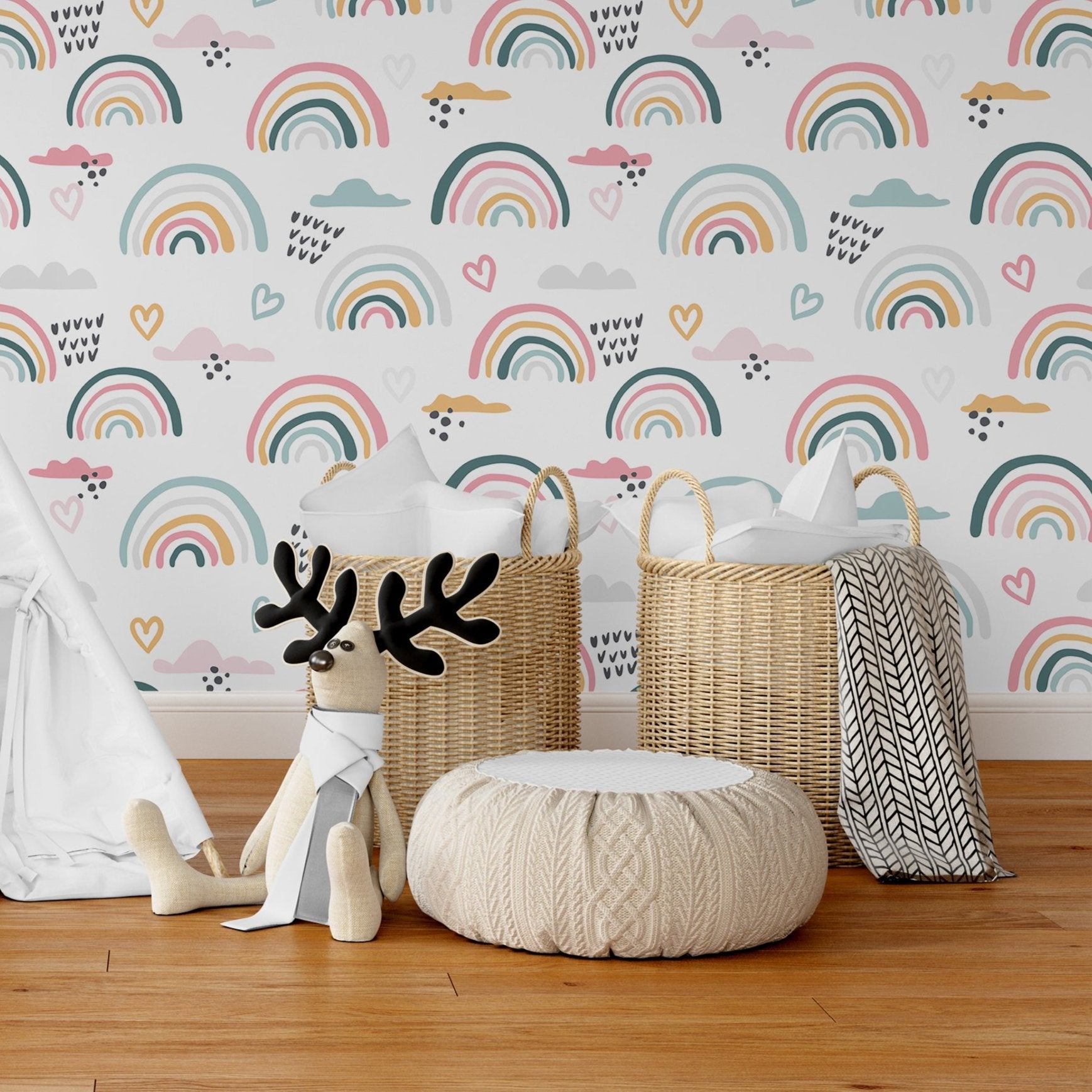 Wallpaper Kids Nursery Dubai Peps Wall A set of children's decor featuring a reindeer, a wicker basket, a knit throw, and a plush toy, all with rainbow and heart patterns, against a wall with a rainbow and hearts wallpaper.