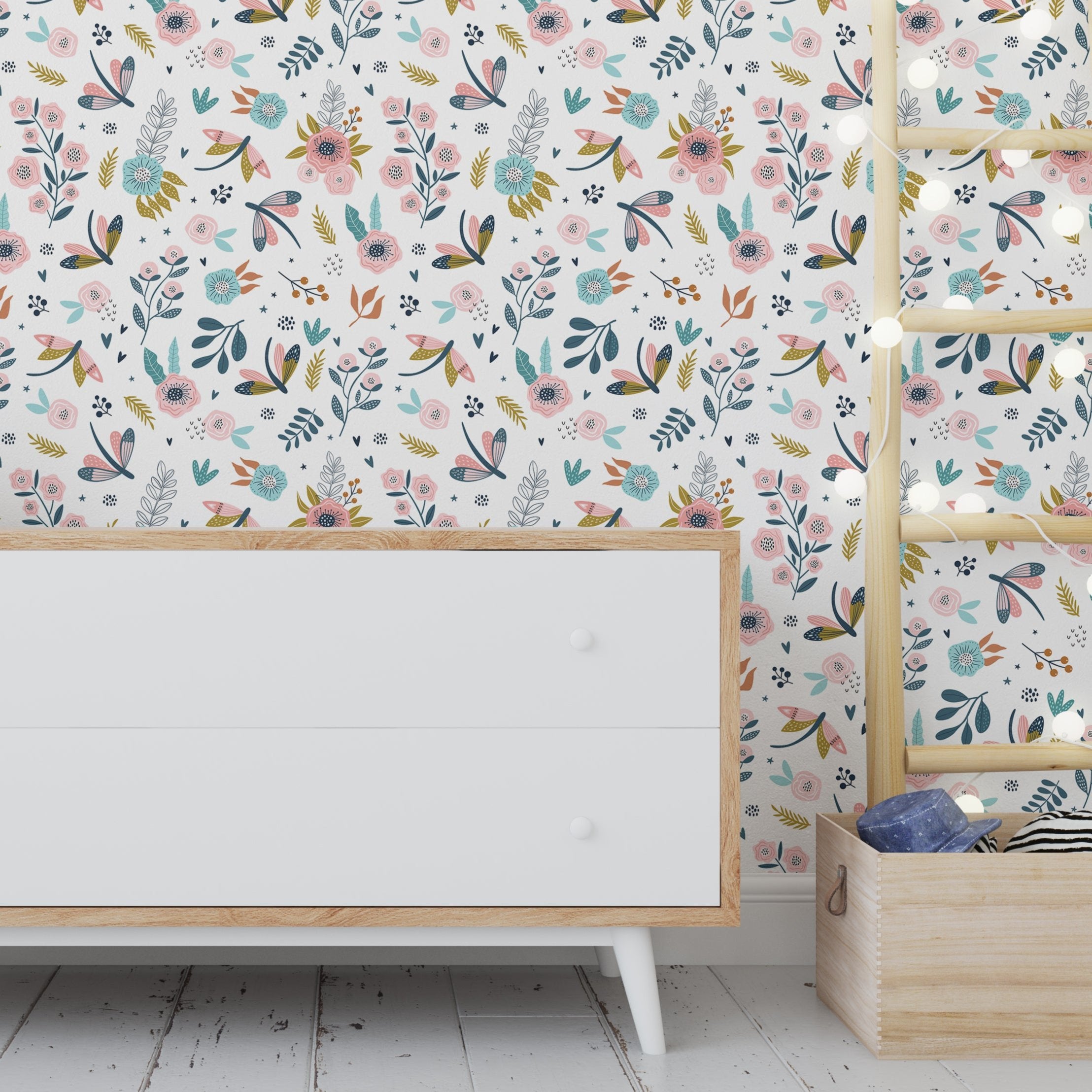 Wallpaper Kids Nursery Dubai Peps Wall A room with 'Charming Flowerfields' wallpaper featuring a colorful floral pattern. The room includes a white cabinet and a wooden shelf with children's toys.