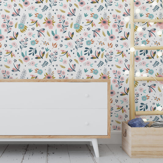 Wallpaper Kids Nursery Dubai Peps Wall A room with 'Charming Flowerfields' wallpaper featuring a colorful floral pattern. The room includes a white cabinet and a wooden shelf with children's toys.