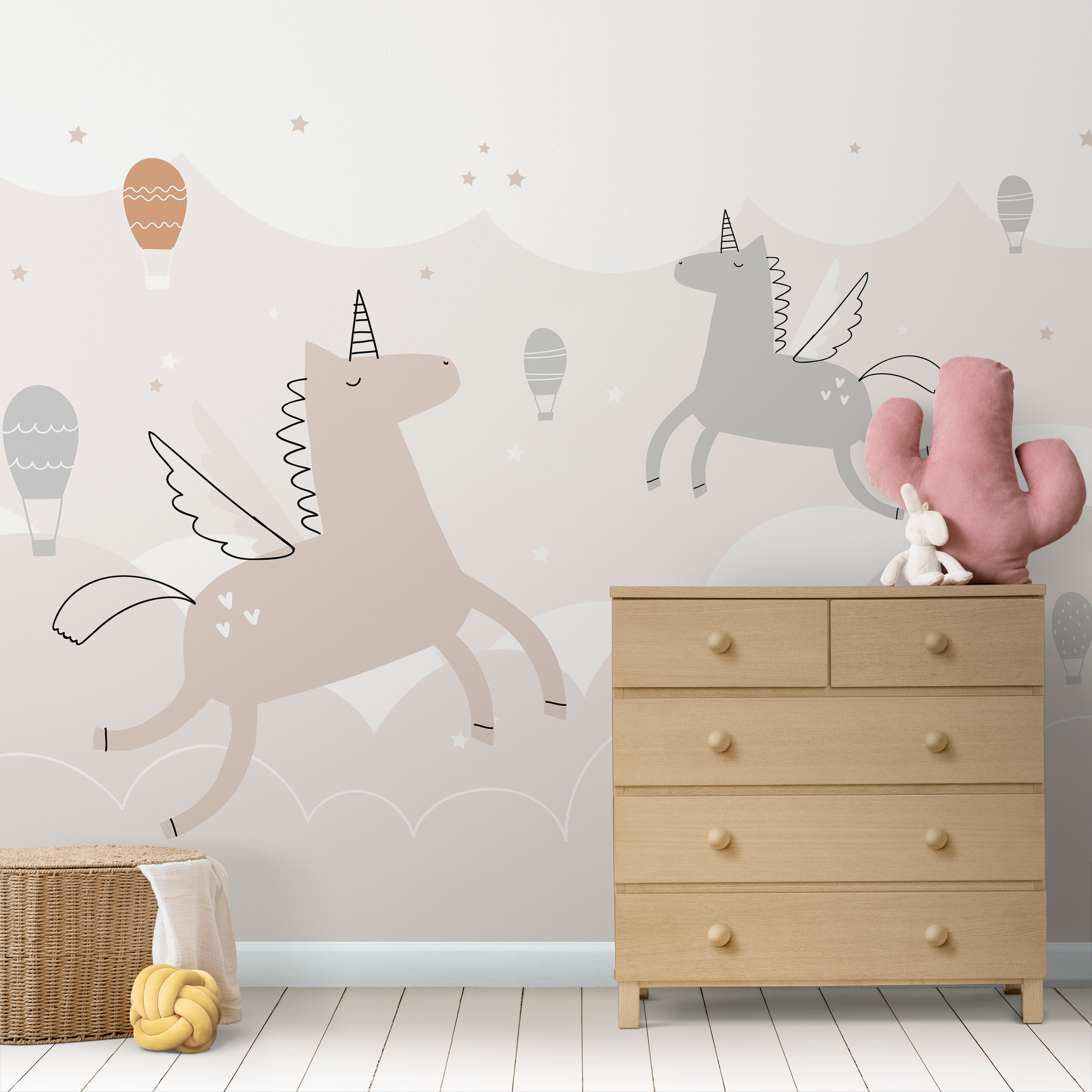 Wallpaper Kids Nursery Dubai Peps Wall A wall decal featuring two jumping unicorns in a room with a wooden dresser and a toy pig in the foreground.