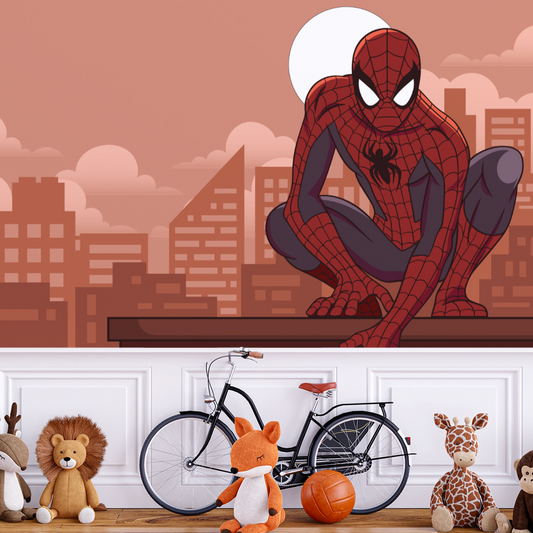Wallpaper Kids Nursery Dubai Peps Wall A wall mural featuring Spiderman sitting on a window sill with a cityscape in the background. The room includes children's toys and a bicycle in the foreground.
