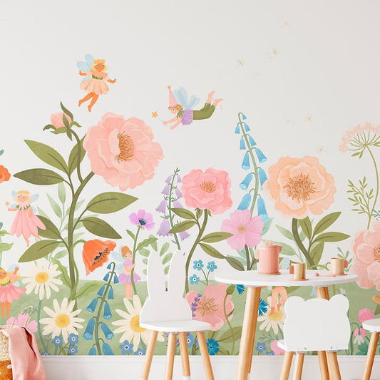 Wallpaper Kids Nursery Dubai Peps Wall A colorful wall mural featuring various flowers and a fairy character, applied on a wall in a room with white furniture.