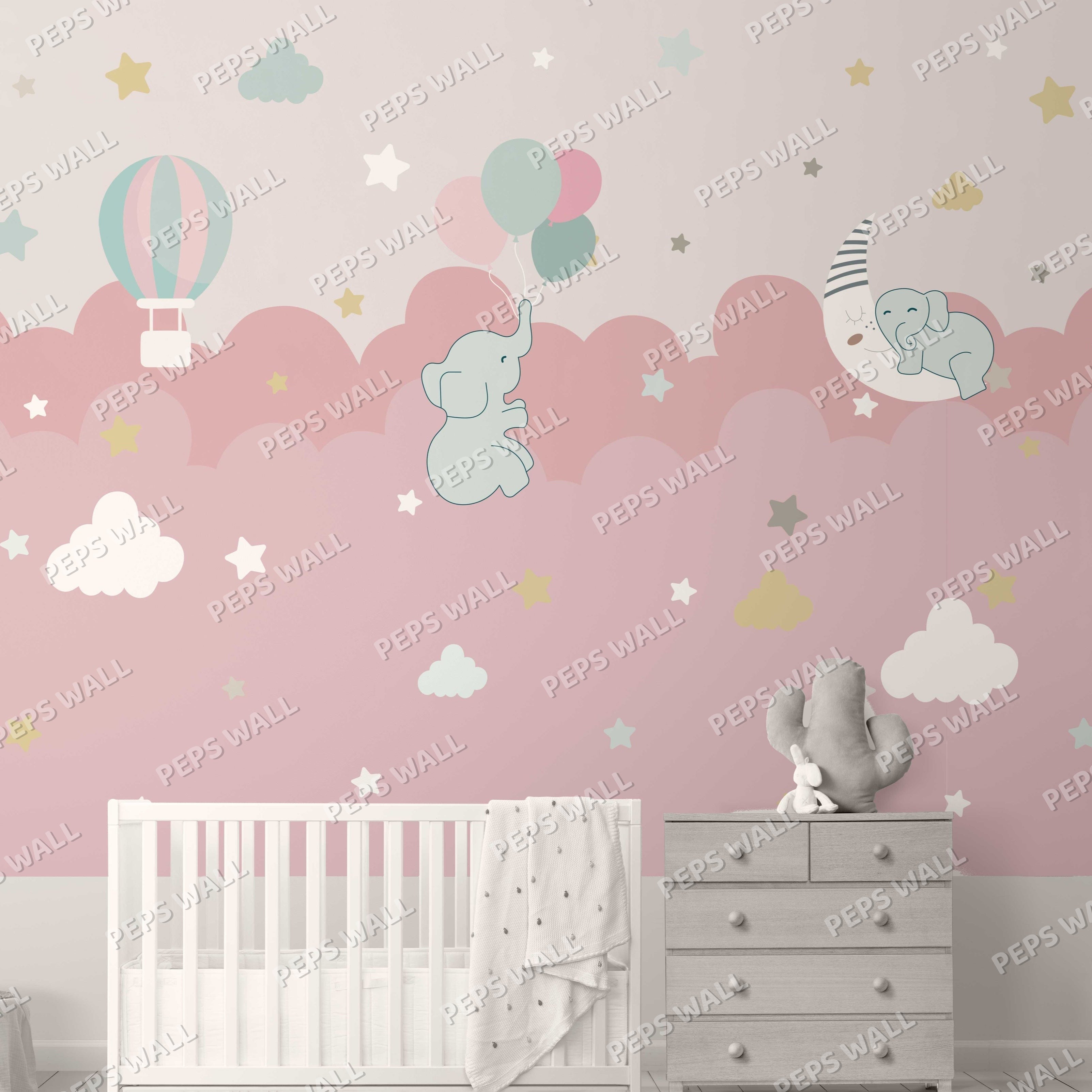 Wallpaper Kids Nursery Dubai Peps Wall Children's room with pink wallpaper featuring clouds, elephants, a moon, and balloons. A crib and a dresser are placed against the wall.