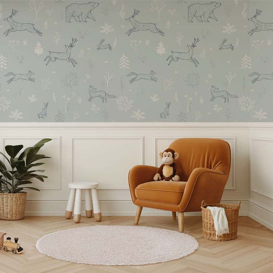 Wallpaper Kids Nursery Dubai Peps Wall Children's room with 'Forrest Trail - Blue' wallpaper featuring animal patterns, a brown armchair, a white round rug, a wooden stool, and decorative plants.