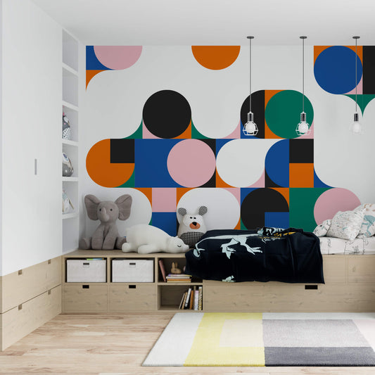 Wallpaper Kids Nursery Dubai Peps Wall A bedroom with geometric patterned wallpaper featuring a mix of solid colors and shapes such as circles and hexagons.