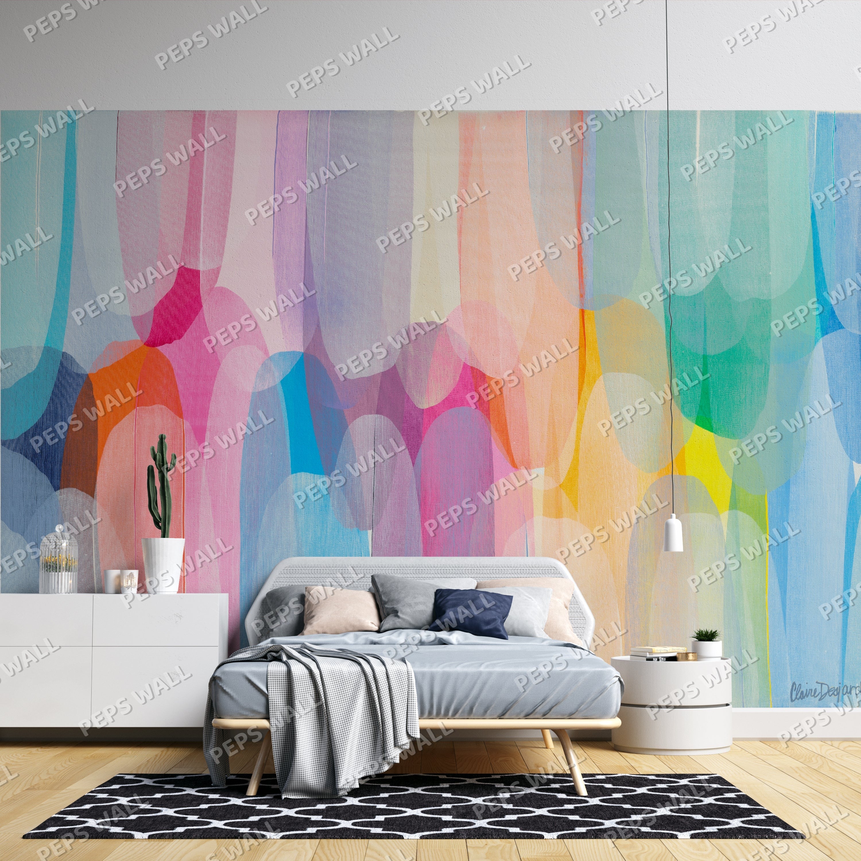 Wallpaper Kids Nursery Dubai Peps Wall A colorful abstract wall mural featuring shades of blue, pink, yellow, and orange applied generously across the wall, with a bed in the foreground and a small cactus on the bedside table.