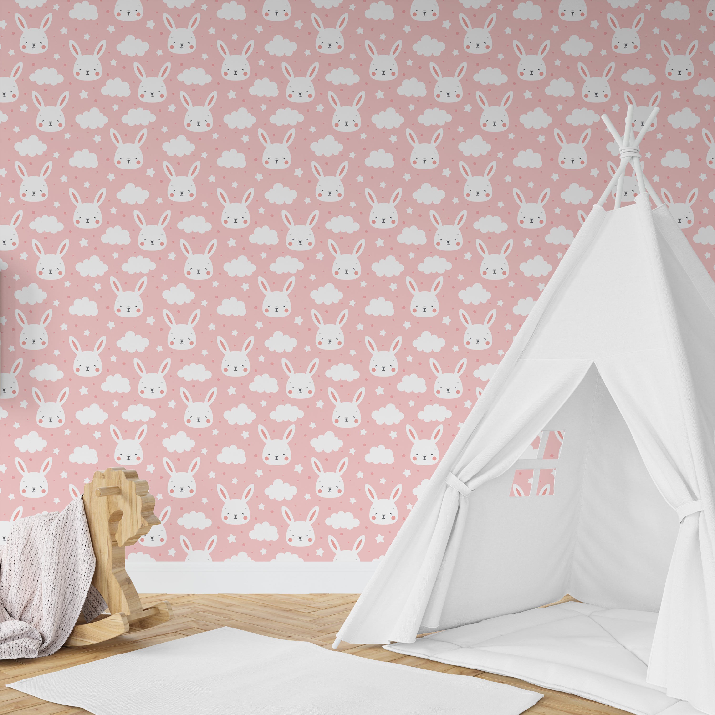 Wallpaper Kids Nursery Dubai Peps Wall A room with white walls featuring a pink background and a pattern of small, cartoon-like rabbits. There is a small, white teepee-style tent with an open doorway in the center of the room.