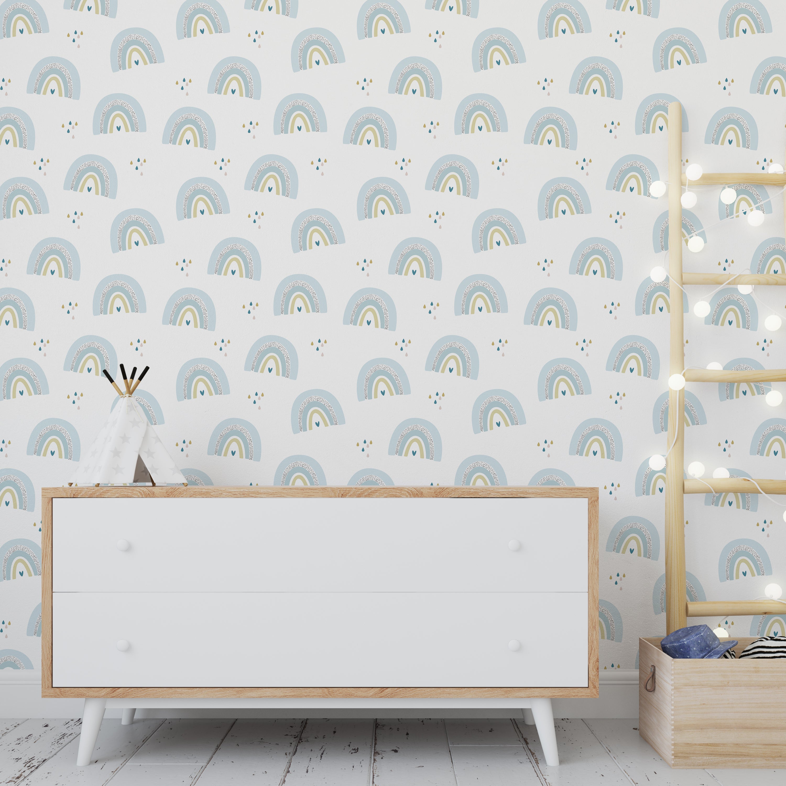 Wallpaper Kids Nursery Dubai Peps Wall A room with blue rainbow patterned wallpaper, featuring a white dresser with wooden legs, a mirror, and a shelf with lights.