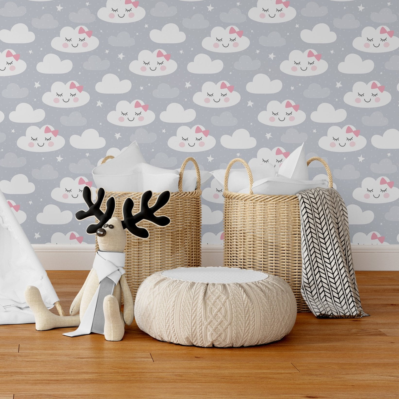 Wallpaper Kids Nursery Dubai Peps Wall A set of wallpapers with cloud and deer designs, accompanied by a plush toy and a woven tote bag, placed on a wooden floor against a white wall.