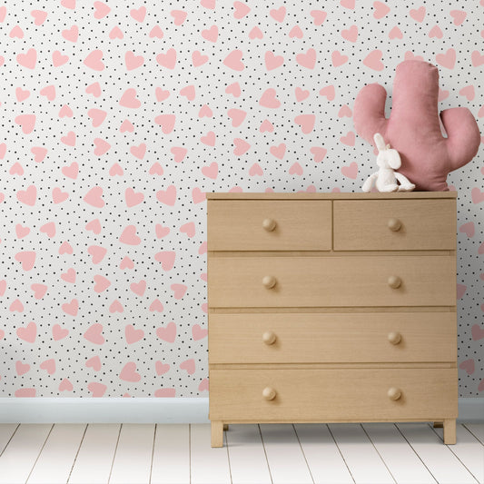 Wallpaper Kids Nursery Dubai Peps Wall A furniture drawer with a pink cactus toy on top, placed against a pink wall with a heart pattern.