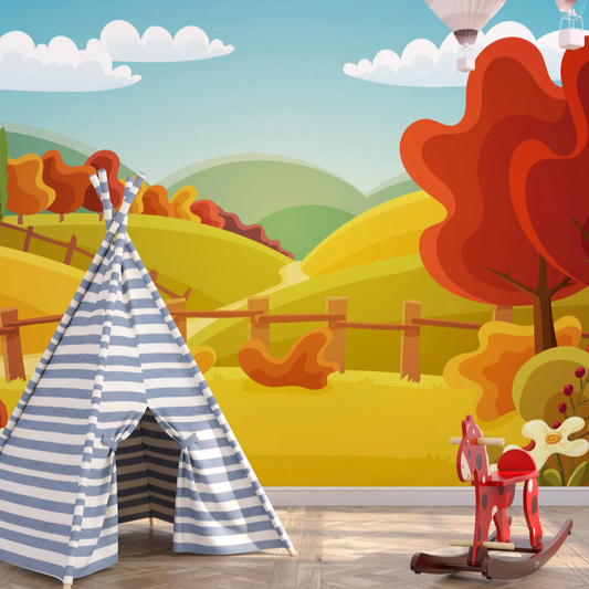 Wallpaper Kids Nursery Dubai Peps Wall A colorful wallpaper featuring a landscape with rolling hills, trees in autumn colors, a blue sky with clouds, and a white teepee tent. There is also a red rocking horse on the floor in front of the wallpaper.