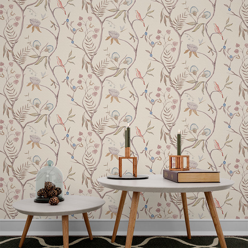 Wallpaper Kids Nursery Dubai Peps Wall A wall adorned with a floral pattern featuring autumnal leaves in shades of beige, brown, and green, with decorative objects on a grey table and shelves.