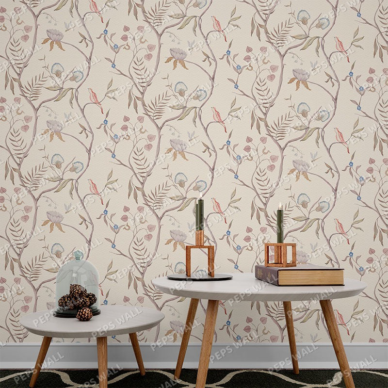 Wallpaper Kids Nursery Dubai Peps Wall A wall adorned with a floral pattern featuring autumnal leaves in shades of beige, brown, and green, with decorative objects on a grey table and shelves.