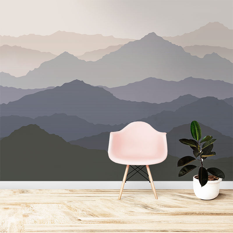 Wallpaper Kids Nursery Dubai Peps Wall A wall mural featuring a landscape with mountain tops in a gradient of gray and blue hues, with a pink chair and a potted plant in the foreground.