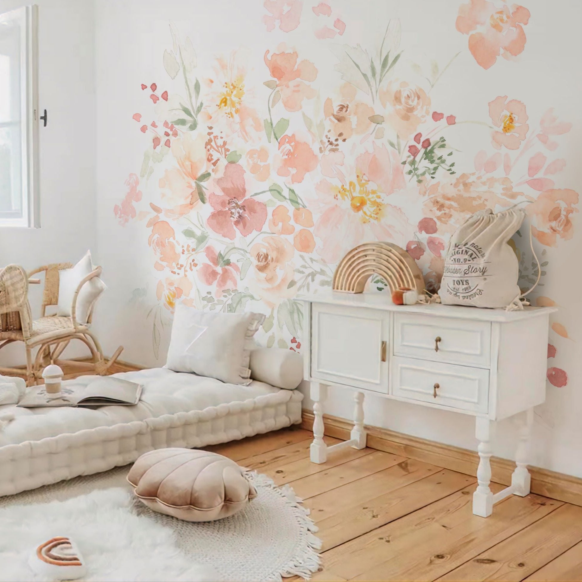 Wallpaper Kids Nursery Dubai Peps Wall A room with a wall adorned with pastel-colored floral wallpaper, featuring a white furniture set and a cozy seating arrangement.