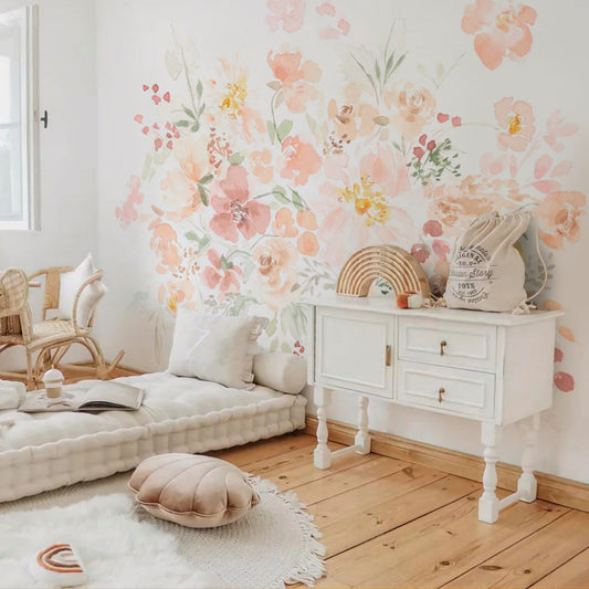 Wallpaper Kids Nursery Dubai Peps Wall A room with a wall adorned with pastel-colored floral wallpaper, featuring a white furniture set and a cozy seating arrangement.