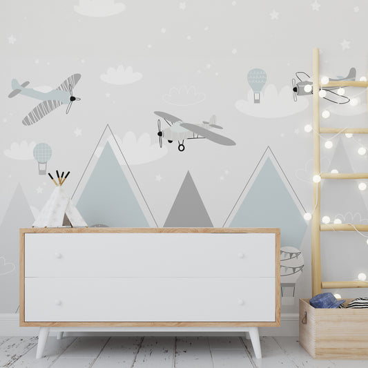 Wallpaper Kids Nursery Dubai Peps Wall A wall decal featuring various planes and hot air balloons in a stylized mountainous landscape with blue sky and stars.