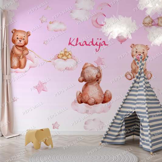 Wallpaper Kids Nursery Dubai Peps Wall A wallpaper featuring cartoon-style teddy bears with a pink background, clouds, and the name 'Khadija' written on it. Part of a children's room decor.