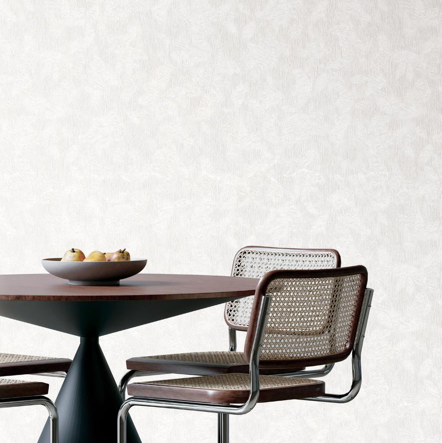 White textured fabric with a subtle gray leaf pattern.